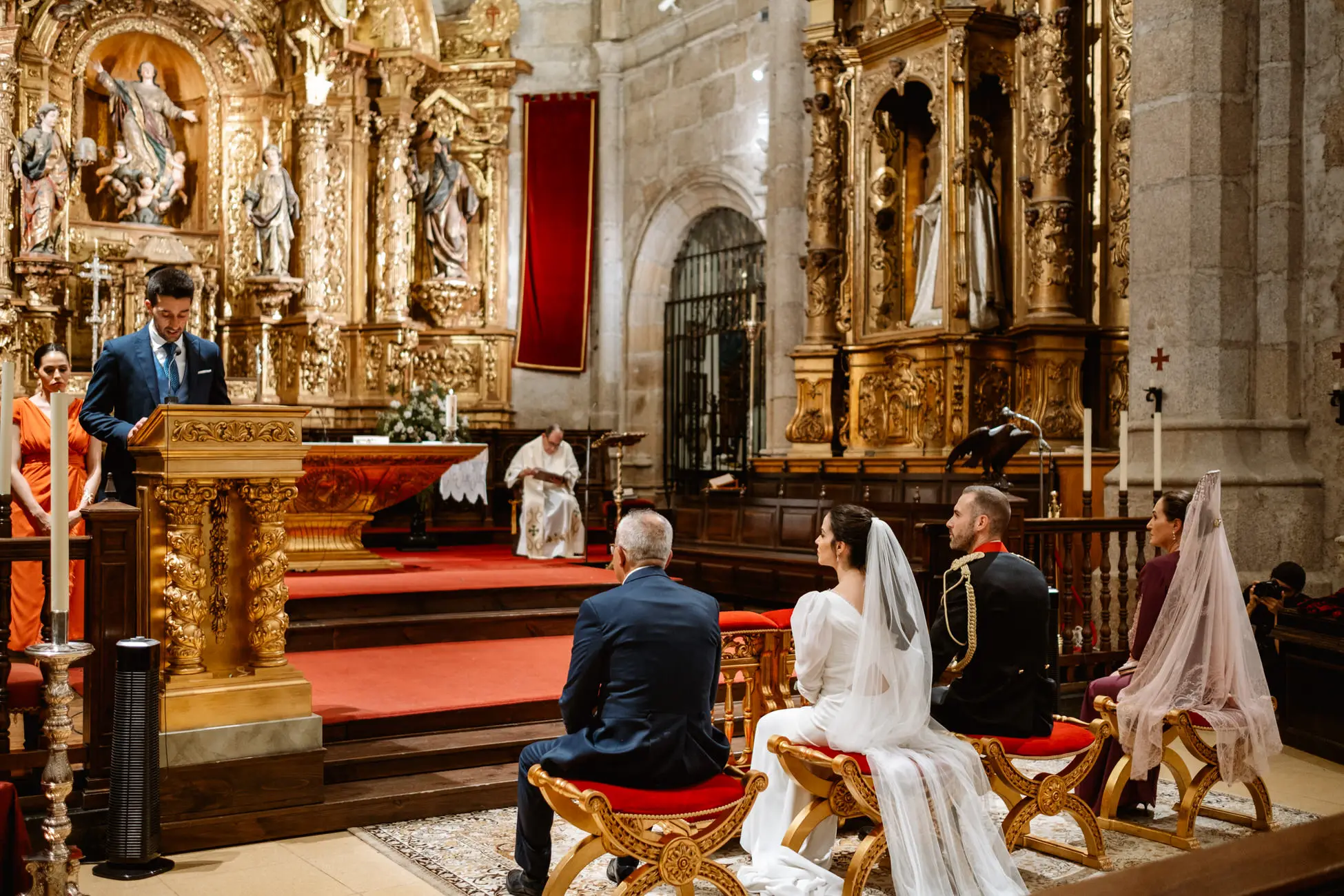 Lectura durante la ceremonia junto al retablo dorado, en Mérida