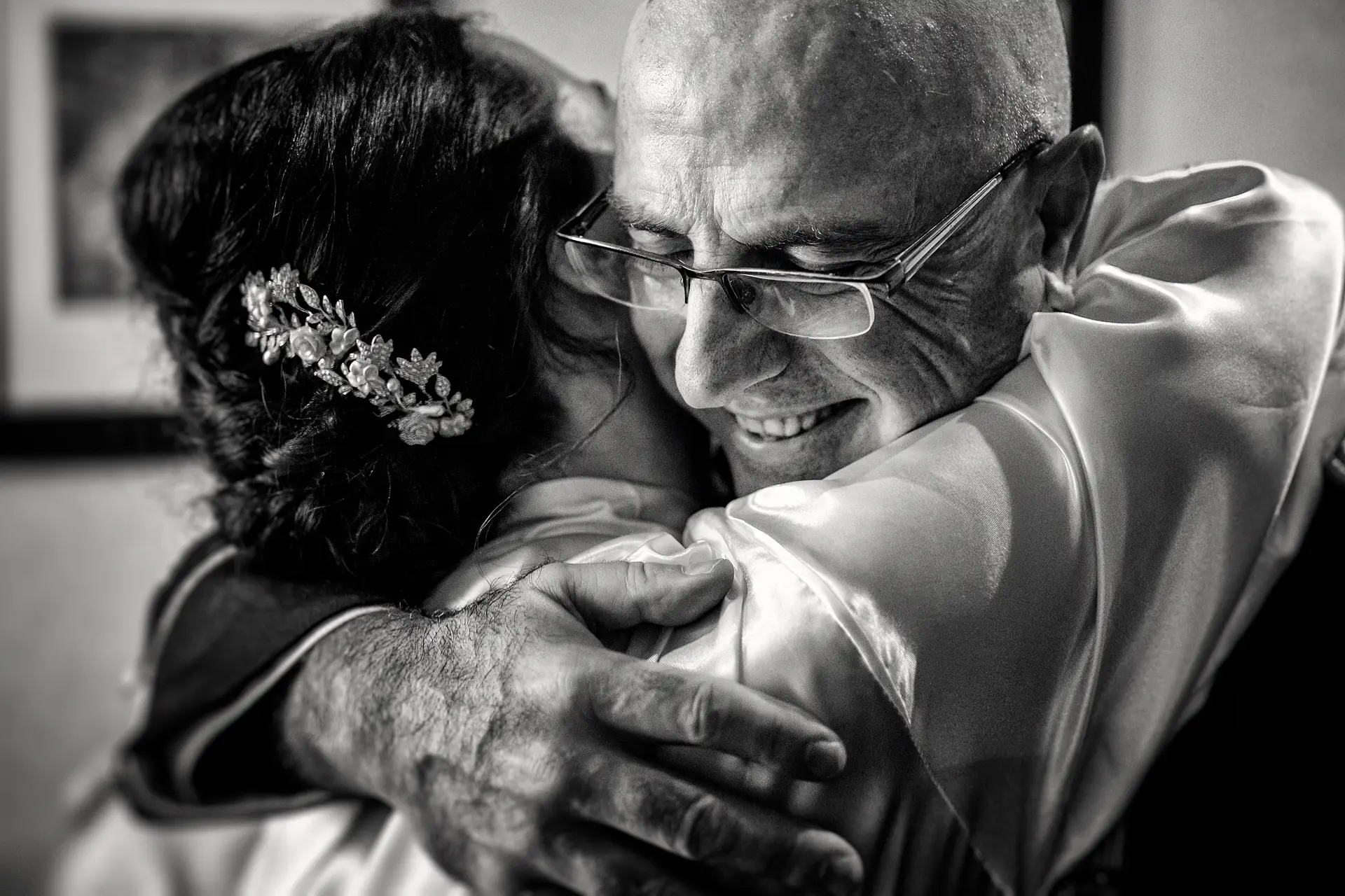 Un padre abraza a su hija, la novia, durante los preparativos de su boda en Badajoz, en blanco y negro