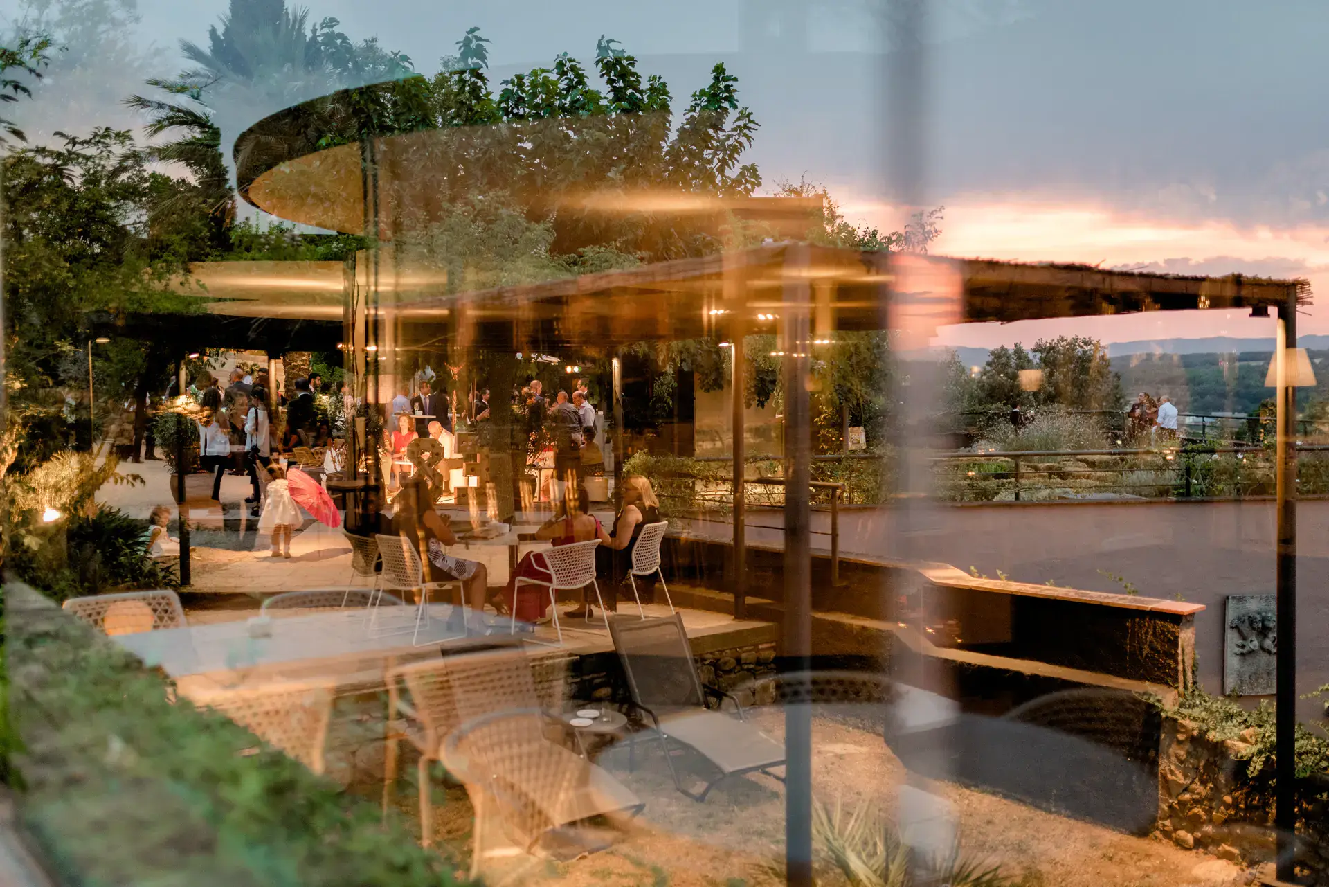 Salón del banquete iluminado al anochecer visto a través del cristal, en el Castell d'Empordà, Girona