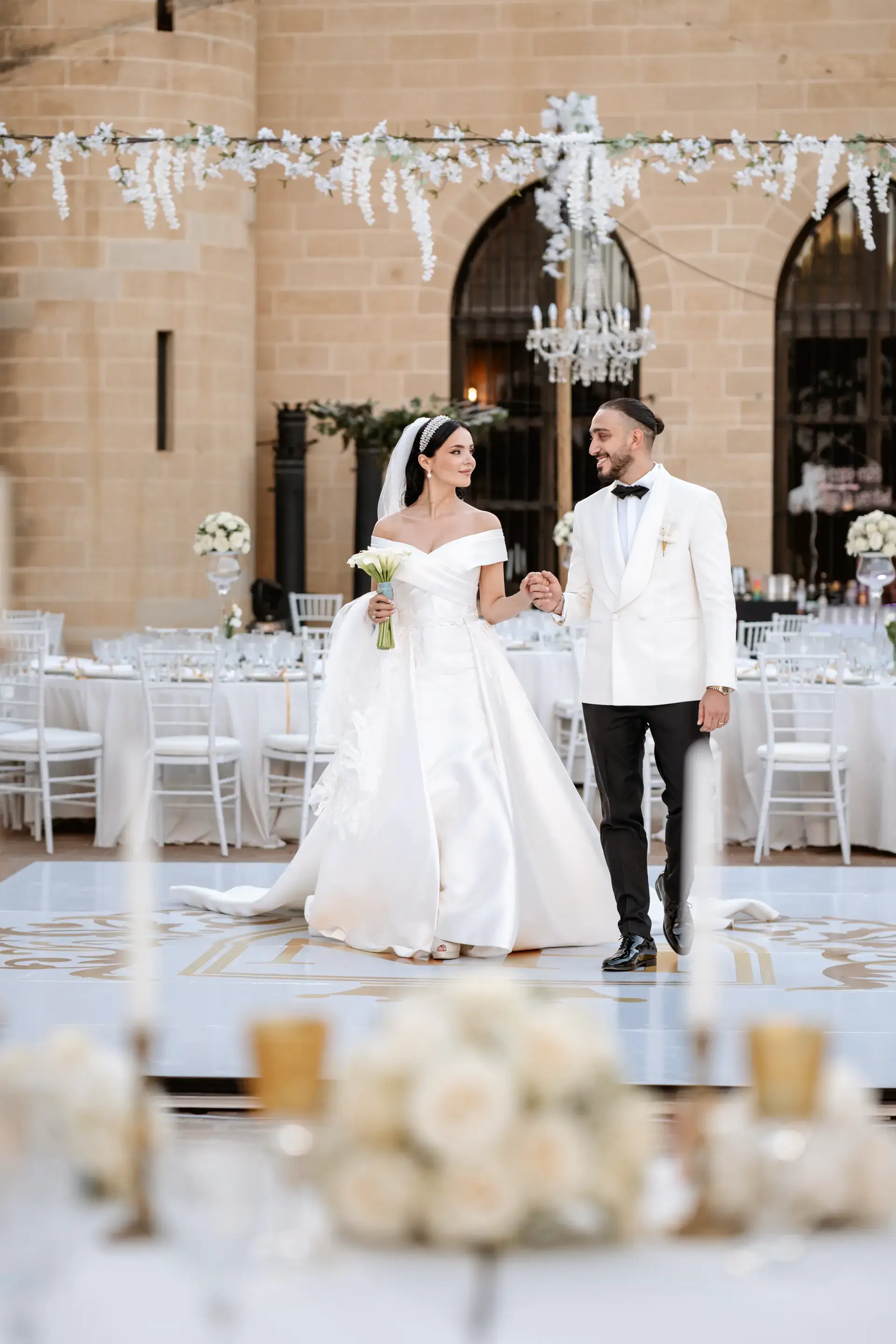 Nicole y Haytham en la pista del banquete bajo lámparas de cristal, en Córdoba
