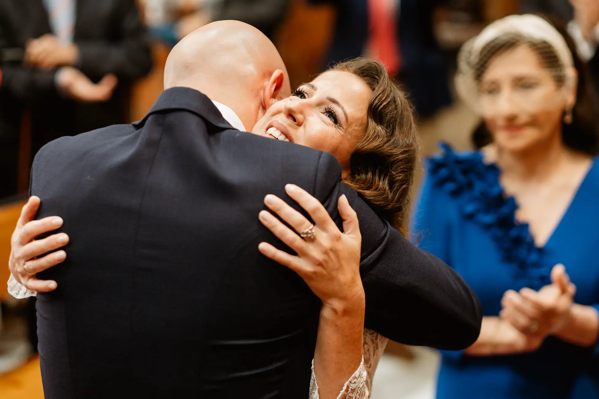 La novia abraza a una invitada al terminar la ceremonia en la iglesia