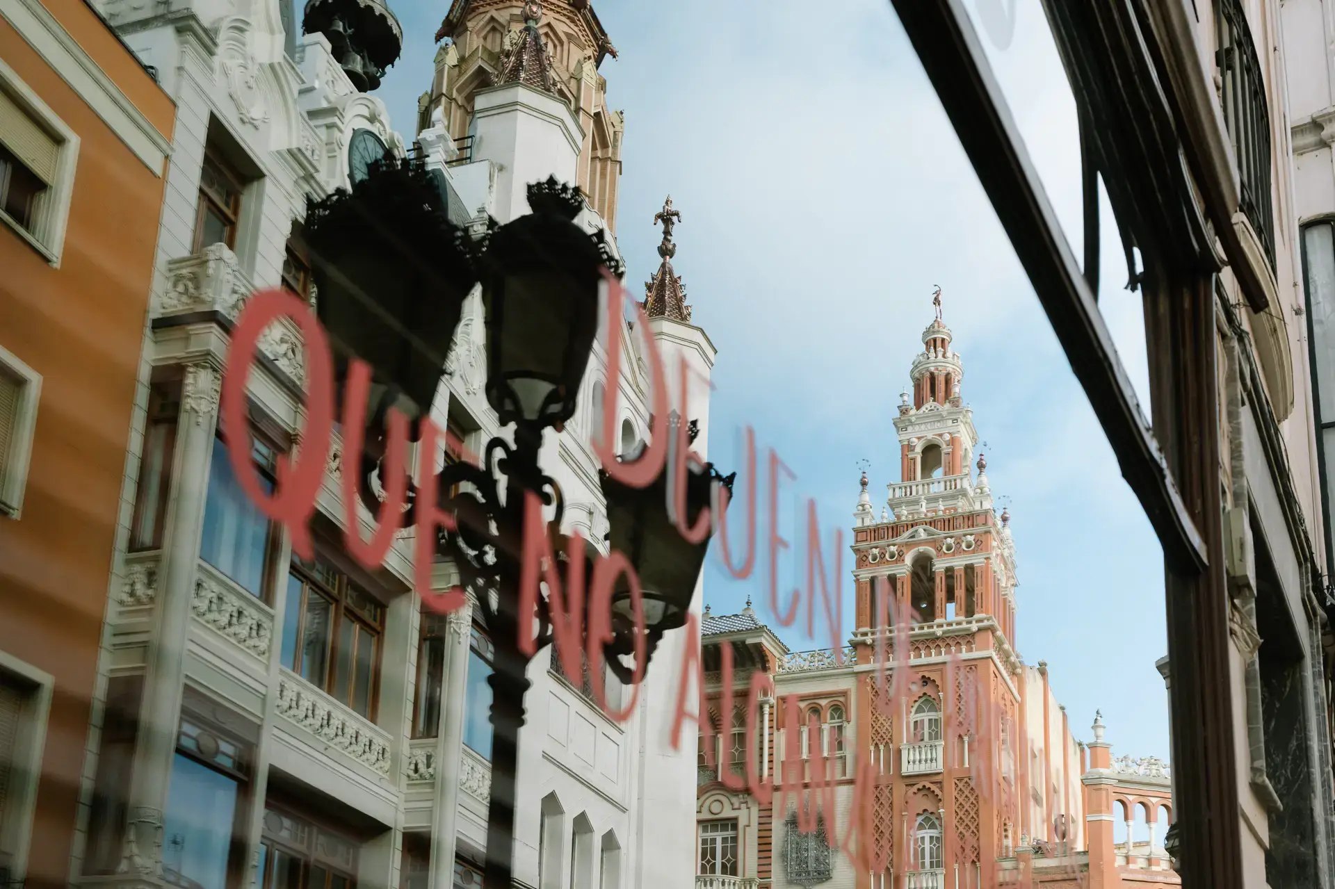 Edificio de La Giralda de Badajoz reflejado en un escaparate