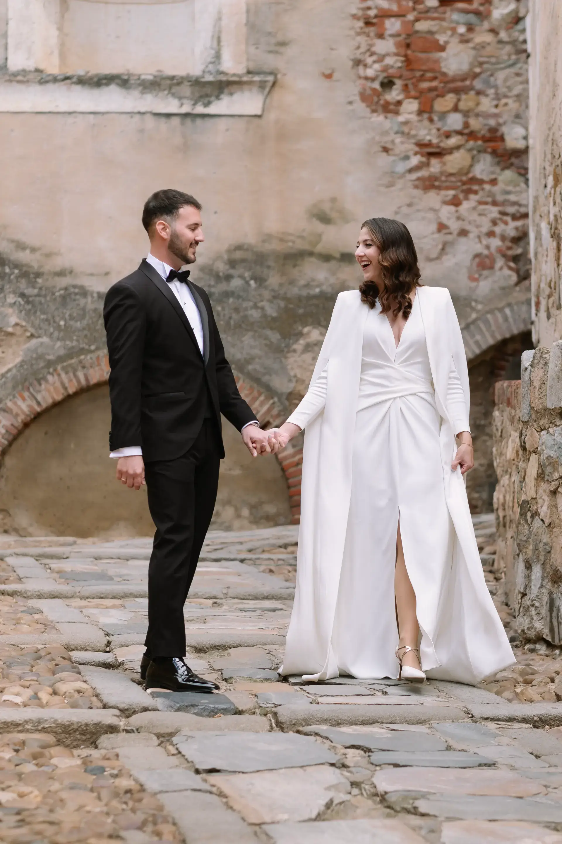 Ana y Jorge de la mano en un rincón de piedra de la Alcazaba de Badajoz