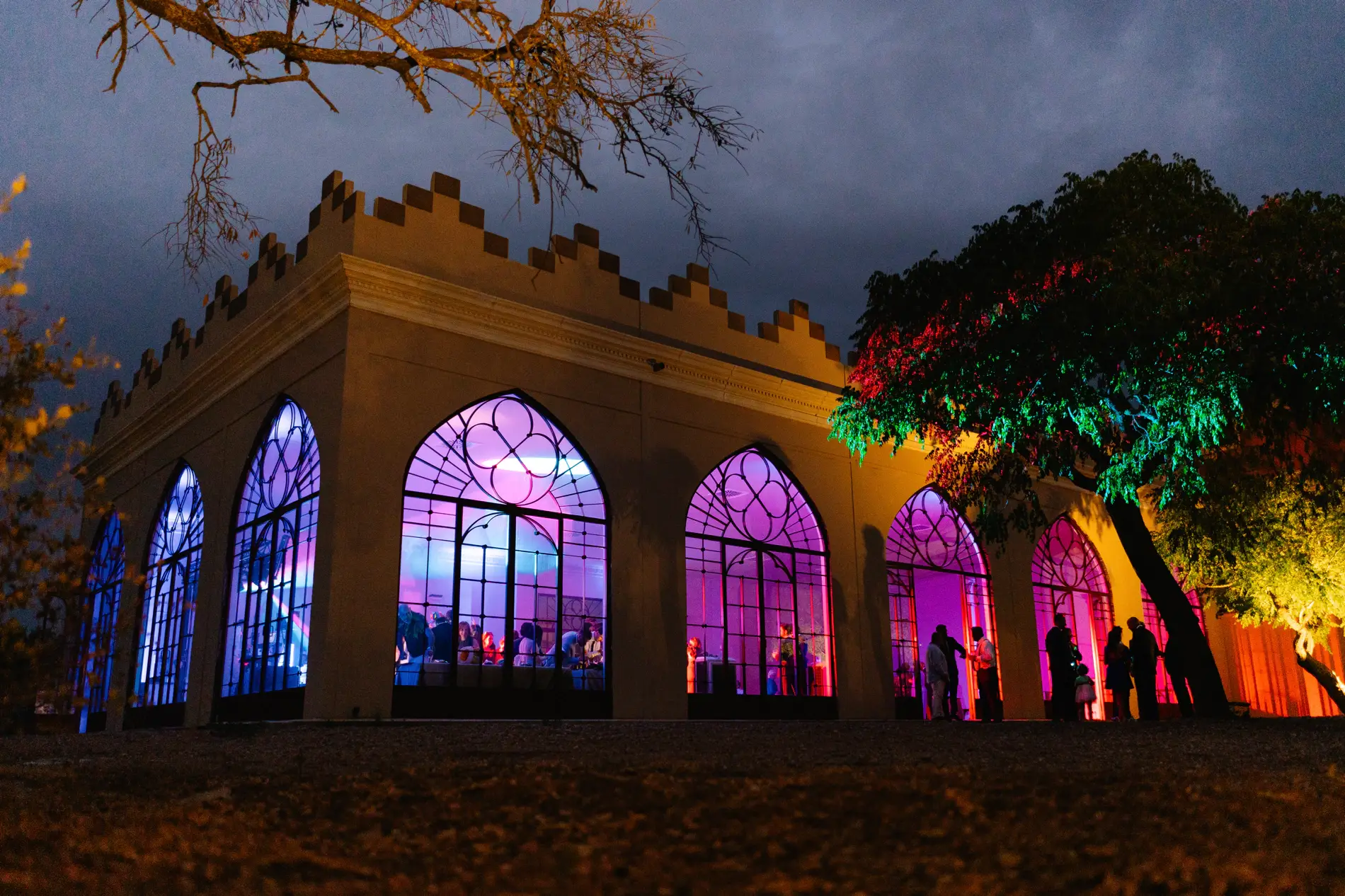 Salón de ventanales arqueados de Casa Colorada iluminado de noche