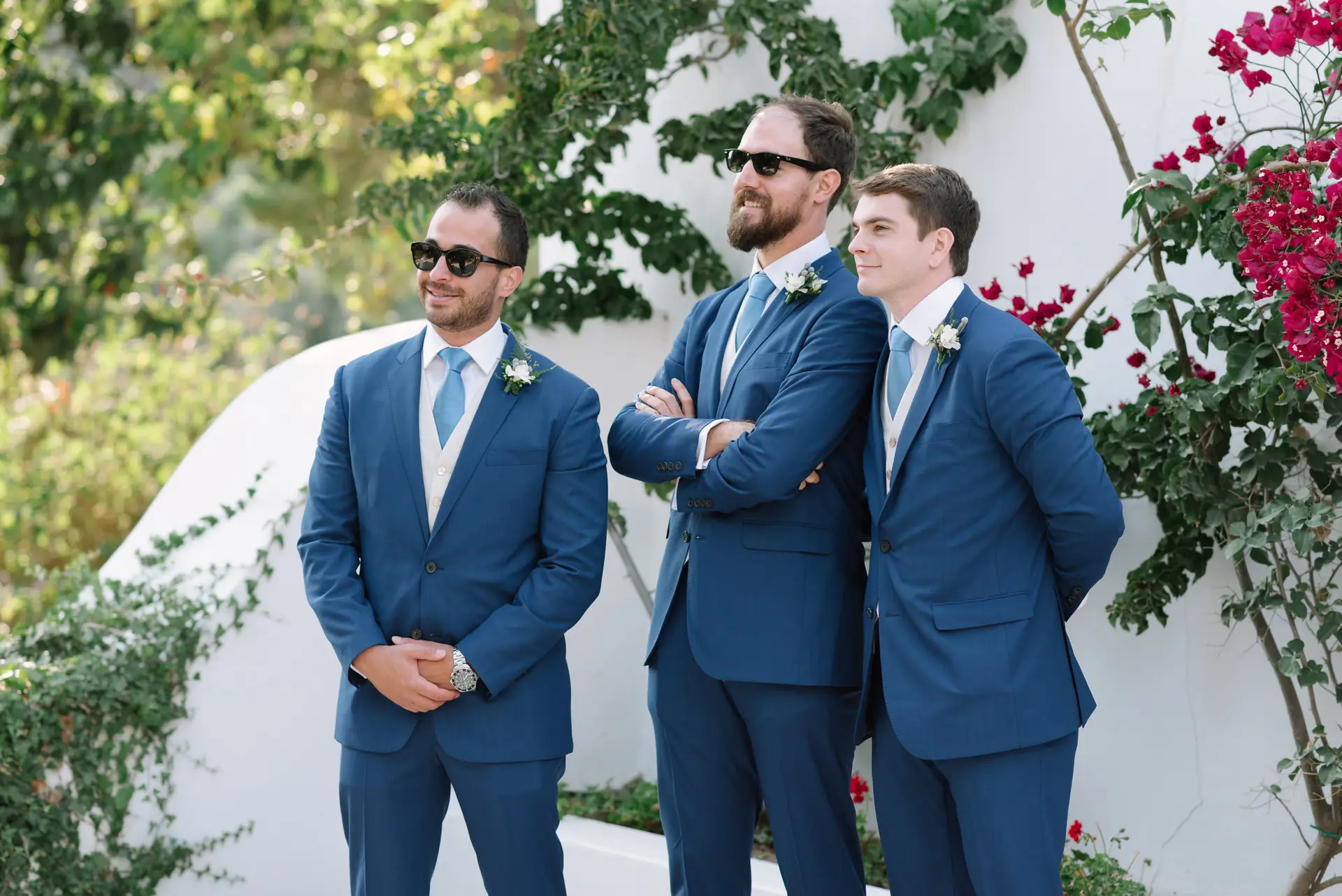 Quinn y dos padrinos con gafas de sol junto a una buganvilla, en la Quinta da Grila, Lisboa