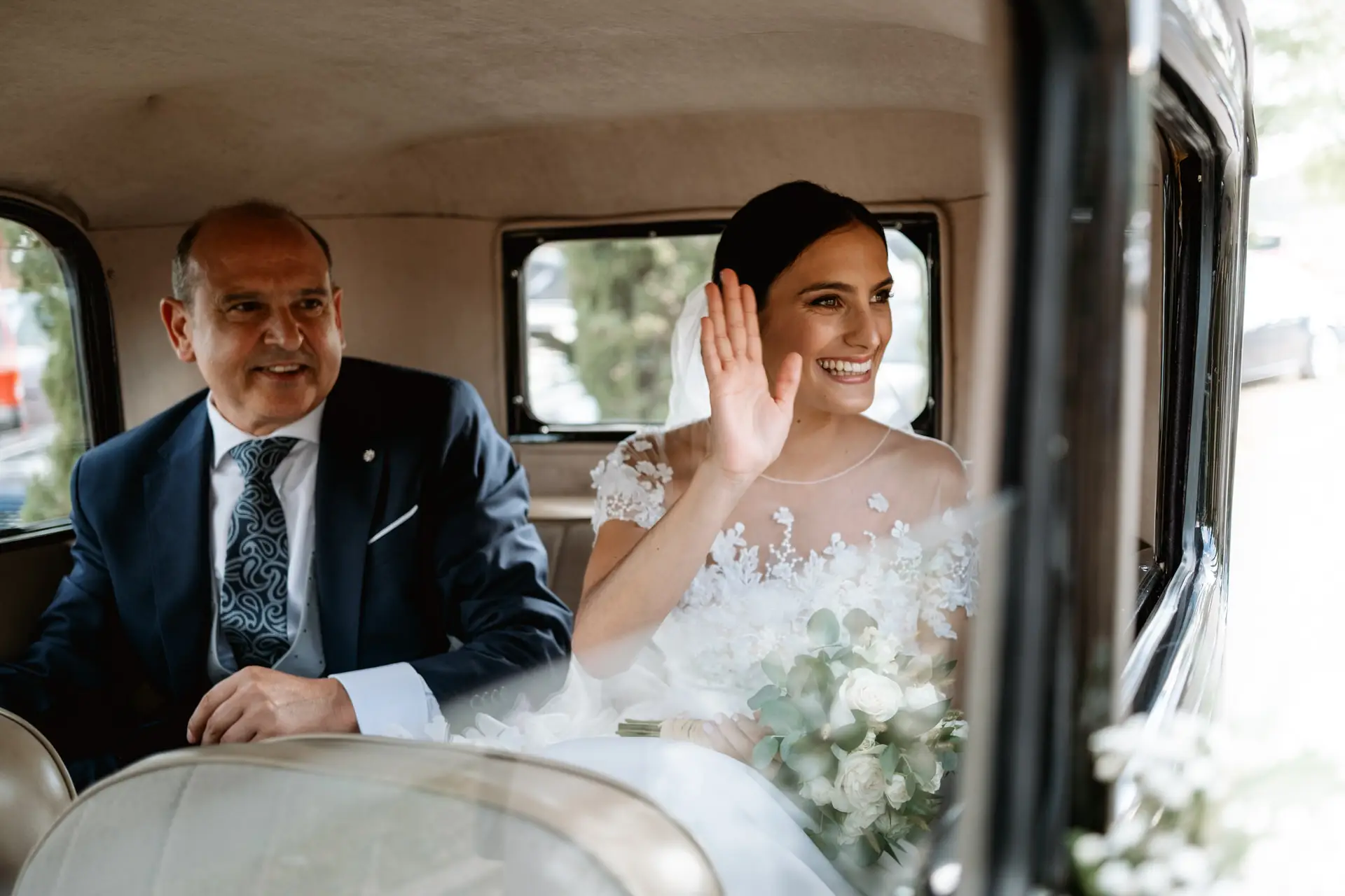 Rocío saluda desde el coche clásico junto a su padre, en Jerez de los Caballeros
